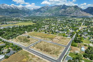 Aerial overview of property's location with mountains, nearby suburban area, and property parcel outlined