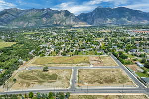 Aerial overview of property's location featuring a mountainous background and property parcel outlined