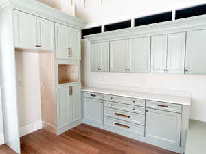 Kitchen with light wood-style floors, white cabinetry, and light countertops