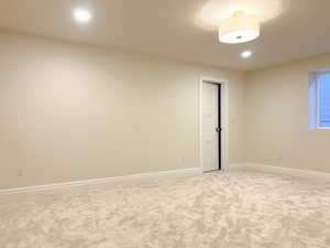 Spare room featuring light carpet and recessed lighting