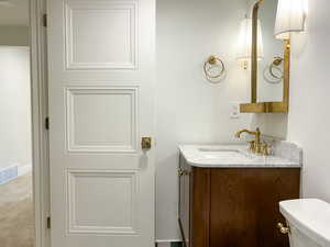 Half bath featuring vanity and toilet