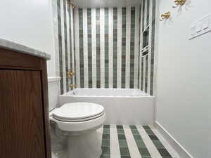 Bathroom featuring shower / tub combination and toilet