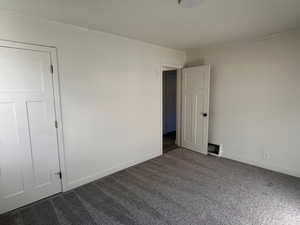 Unfurnished room with carpet and baseboards