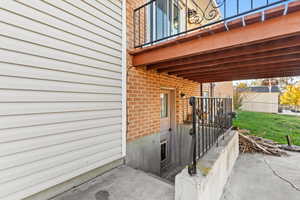 Doorway to property with brick siding and a patio area
