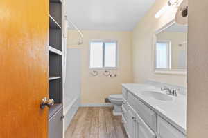 Full bath with vanity, light wood-style floors, and bathing tub / shower combination