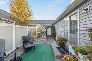 View of patio / terrace with a greenhouse and an outbuilding