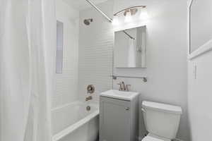 Full bath featuring shower / tub combo and vanity