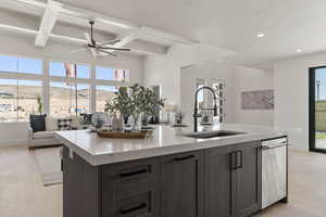 Kitchen featuring light wood finished floors, open floor plan, beamed ceiling, light stone counters, and coffered ceiling