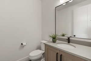Half bath with vanity and toilet