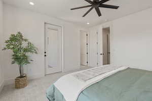 Carpeted bedroom with recessed lighting and a ceiling fan