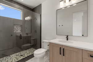 Bathroom featuring vanity and a stall shower