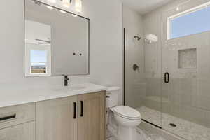 Full bath with vanity and a shower stall