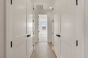 Corridor with recessed lighting and light wood-style floors