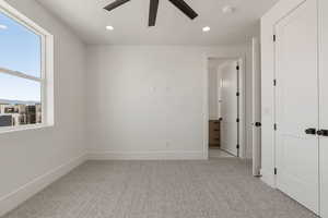 Unfurnished bedroom with light colored carpet, recessed lighting, and a ceiling fan