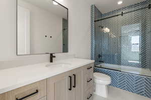 Bathroom featuring vanity and tiled shower / bath combo