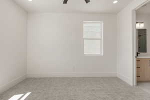 Empty room with recessed lighting, light carpet, and a ceiling fan