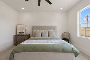 Carpeted bedroom featuring recessed lighting and a ceiling fan