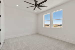 Unfurnished room with light carpet, recessed lighting, and a ceiling fan