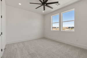 Empty room featuring light colored carpet, recessed lighting, and ceiling fan