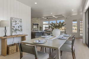 Dining area featuring light wood-style flooring, healthy amount of natural light, ceiling fan, beam ceiling, and recessed lighting