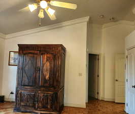Detailed view of ornamental molding and a ceiling fan