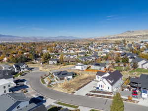 Aerial view of residential area featuring a mountainous background