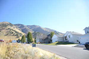 View of asphalt road featuring a mountain view and a residential view