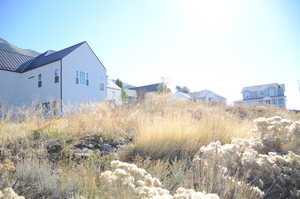 View of side of property with a metal roof and a residential view