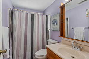 Full bath featuring vanity and a shower with curtain