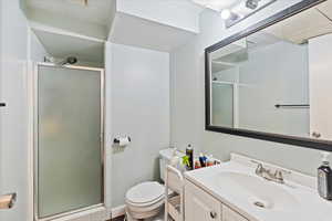 Full bathroom featuring vanity and a shower stall