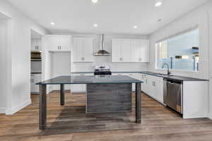Kitchen featuring backsplash, white cabinetry, appliances with stainless steel finishes, and recessed lighting