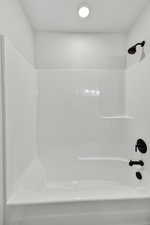 Full bath with washtub / shower combination and recessed lighting