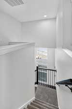 Stairs featuring carpet, a chandelier, and recessed lighting