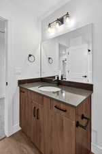 Bathroom featuring vanity and light wood-style floors