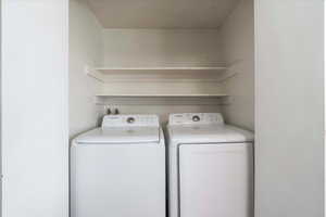 Laundry room with washer and clothes dryer