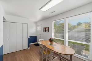 Dining area with light wood-style floors and baseboards