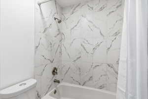 Bathroom featuring shower / bath combo with shower curtain