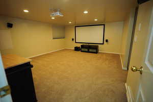 Home theater with recessed lighting and light colored carpet