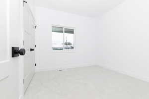 bedroom 2  featuring light carpet and baseboards