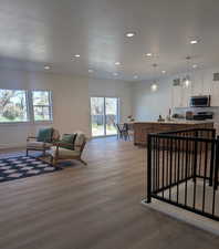 Living room featuring recessed lighting and light wood-type flooring