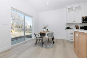 Dining area featuring light wood-style floors and recessed lighting