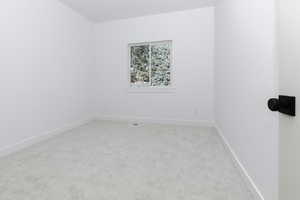 Bedroom  3featuring light carpet and baseboards
