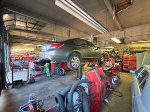 Garage featuring a heating unit and a workshop area