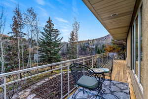 Balcony featuring view of scattered trees