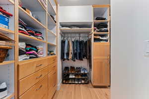 Spacious closet with light wood-type flooring