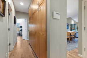 Corridor featuring light extra storage and recessed lighting