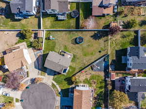 Aerial view of property's location with nearby suburban area