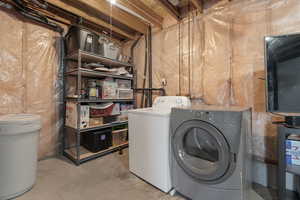 Laundry area featuring concrete floors and washer and dryer