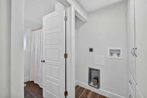Laundry area with electric dryer hookup, washer hookup, and dark wood-style flooring