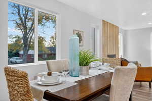 Dining room featuring wood finished floors, recessed lighting, and a textured ceiling